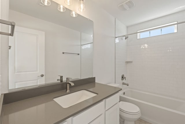 full bathroom with vanity, tiled shower / bath combo, and toilet