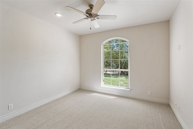 empty room featuring ceiling fan and carpet flooring