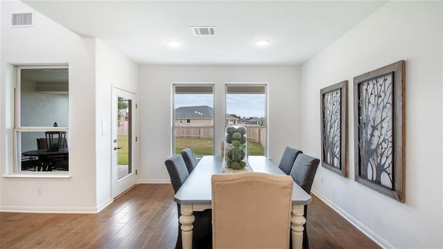 dining space with dark hardwood / wood-style floors