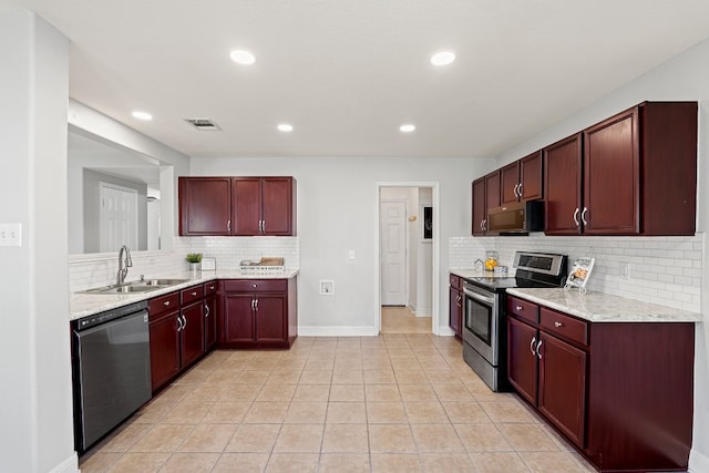 kitchen with decorative backsplash, stainless steel appliances, light tile patterned floors, and sink