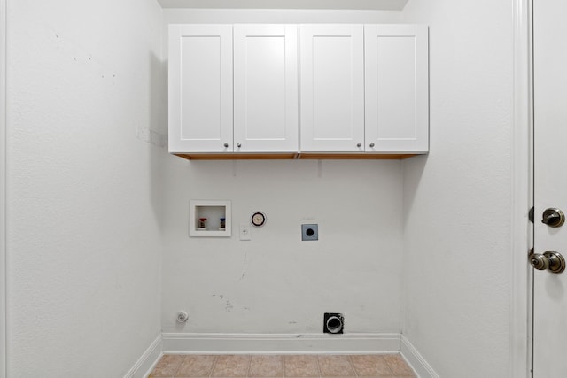 washroom with cabinets, light tile patterned flooring, electric dryer hookup, hookup for a washing machine, and gas dryer hookup