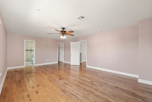 empty room with ceiling fan and light hardwood / wood-style floors