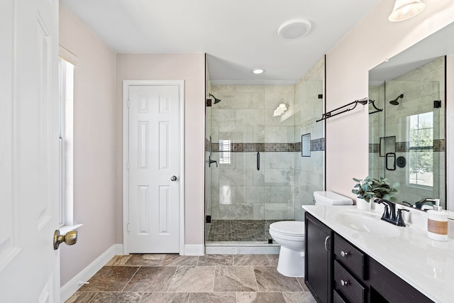 bathroom featuring an enclosed shower, vanity, and toilet