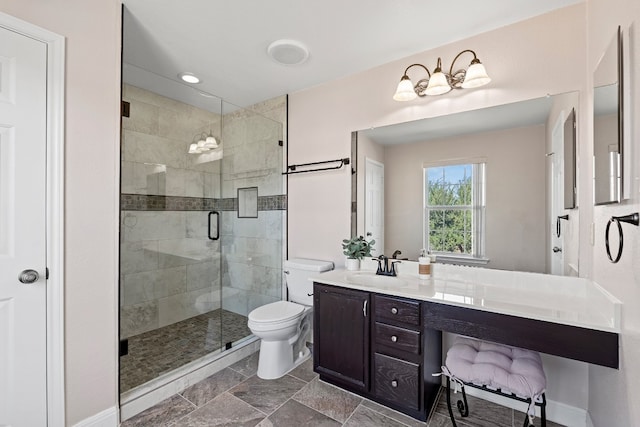 bathroom with a shower with shower door, vanity, and toilet