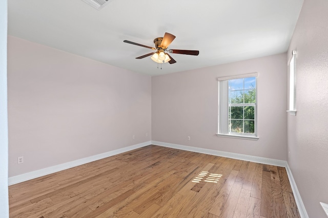 spare room featuring ceiling fan and light hardwood / wood-style flooring