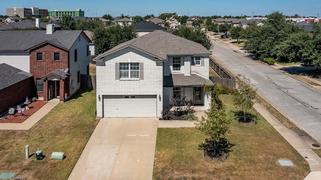 view of front of house with a front yard and a garage