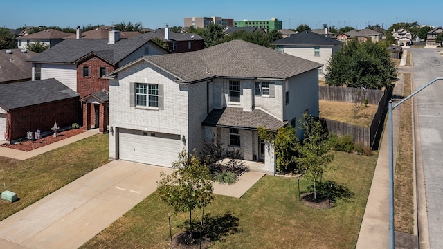 view of front of home with a garage and a front lawn