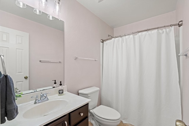 bathroom featuring vanity, toilet, and a shower with shower curtain