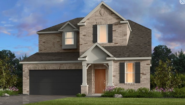 view of front of home featuring a garage and a lawn