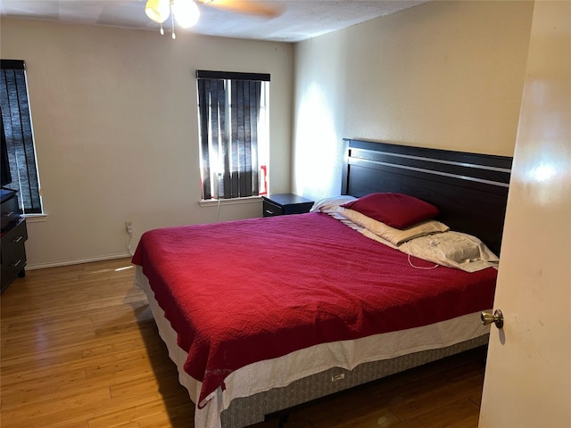 bedroom with ceiling fan and light hardwood / wood-style floors