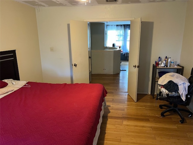 bedroom featuring ceiling fan and light hardwood / wood-style flooring