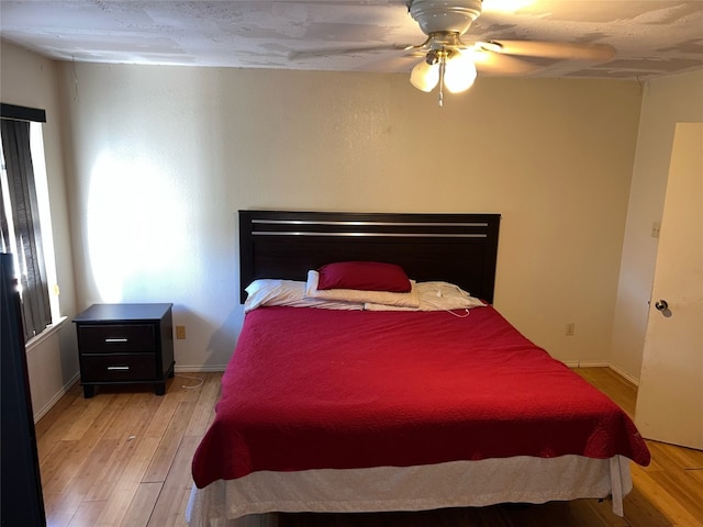 bedroom featuring ceiling fan and light hardwood / wood-style flooring