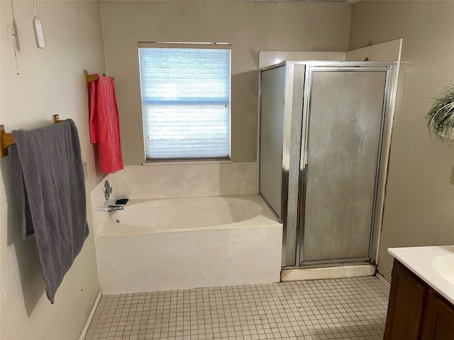 bathroom featuring tile patterned flooring, independent shower and bath, and vanity