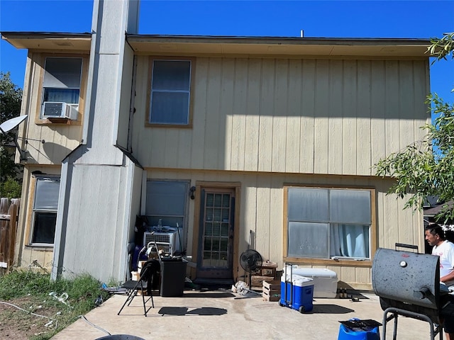 rear view of house featuring cooling unit and a patio area