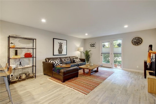 living area with baseboards, recessed lighting, and light wood-style floors