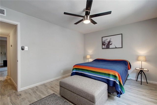 bedroom featuring ceiling fan, wood finished floors, and baseboards