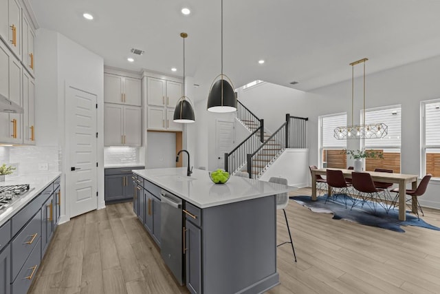 6508 Cowman Way, Austin, TX 78747 - kitchen with appliances with stainless steel finishes, light wood-style floors, light countertops, tasteful backsplash, and recessed lighting