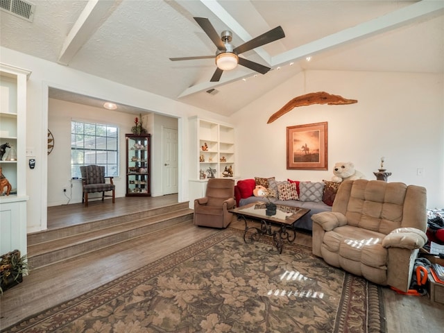 living room with a textured ceiling, vaulted ceiling with beams, dark hardwood / wood-style floors, and ceiling fan