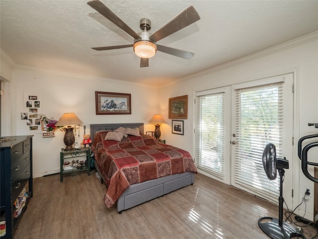 bedroom with a textured ceiling, crown molding, wood-type flooring, ceiling fan, and access to outside