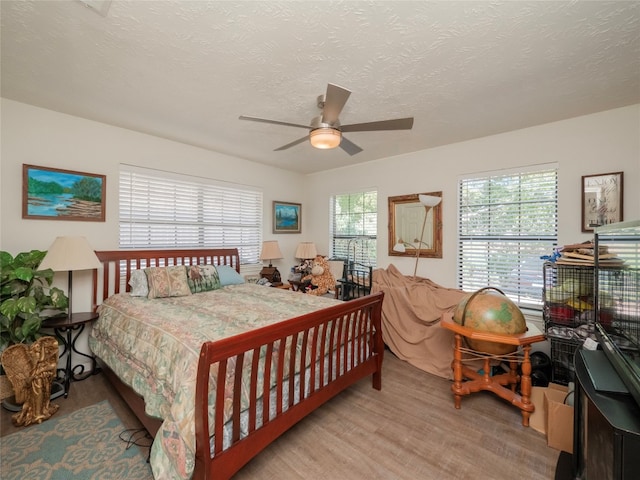 bedroom featuring a textured ceiling and ceiling fan