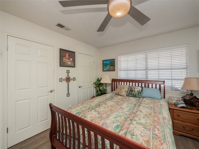 bedroom with ceiling fan and dark hardwood / wood-style floors