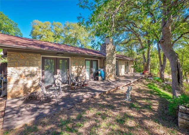 rear view of property with french doors