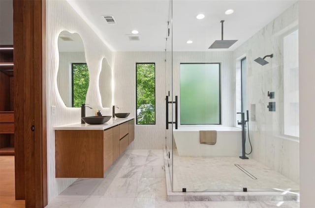 bathroom featuring shower with separate bathtub and vanity