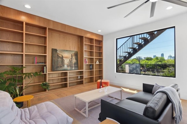 living room with ceiling fan and hardwood / wood-style floors