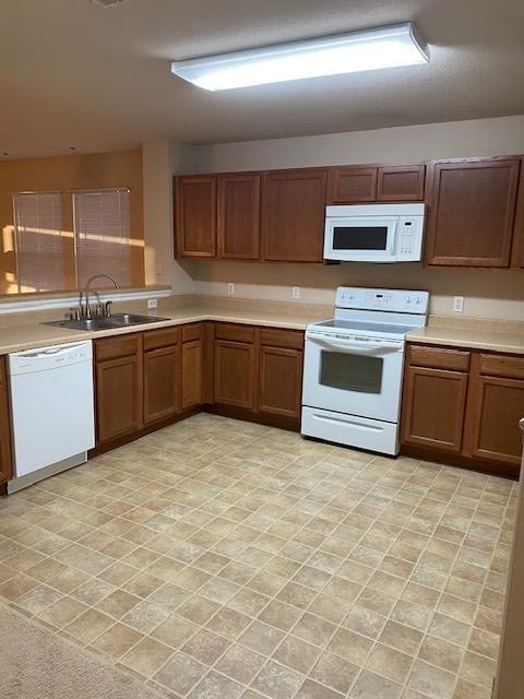 kitchen featuring sink and white appliances