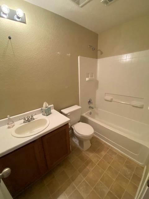 full bathroom featuring bathtub / shower combination, vanity, and toilet