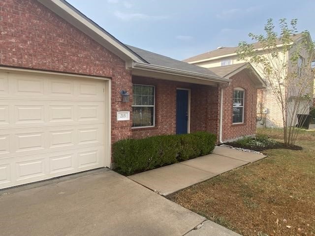 view of front of property featuring a garage and a front lawn