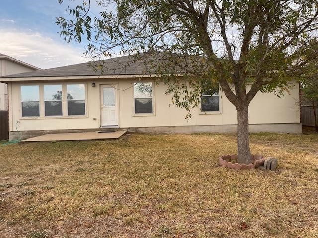 rear view of property with a patio area and a yard