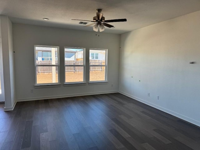 empty room with dark hardwood / wood-style floors and ceiling fan