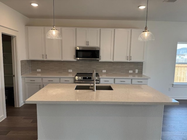 kitchen featuring appliances with stainless steel finishes, dark wood-style flooring, backsplash, and white cabinetry