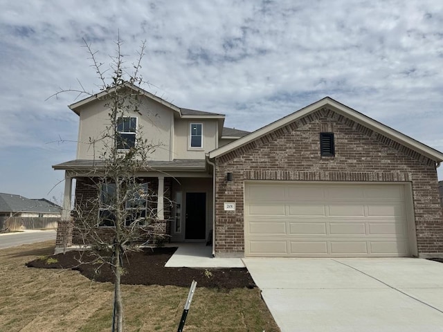 traditional home featuring brick siding, driveway, and an attached garage