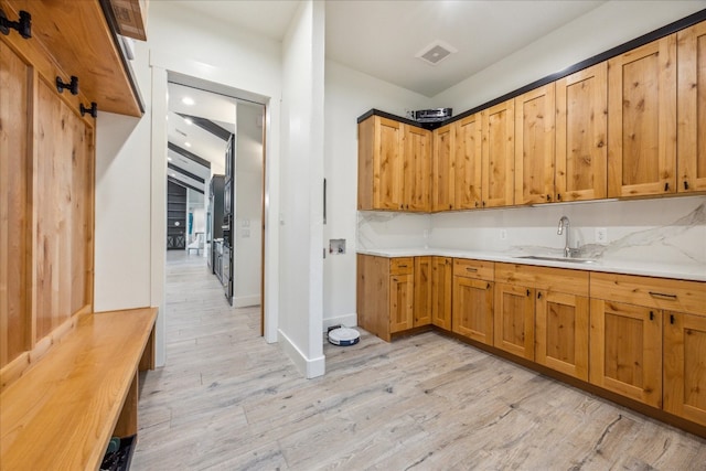 kitchen with light wood-type flooring and sink