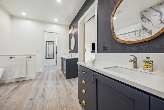 bathroom with hardwood / wood-style flooring and vanity