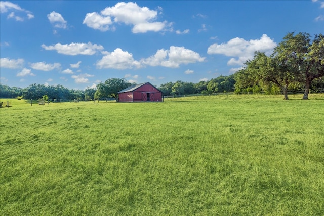 view of yard with an outbuilding and a rural view