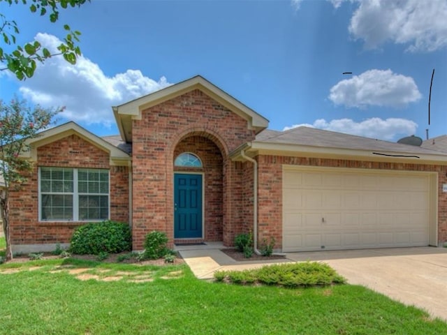 view of front of house with a front lawn and a garage