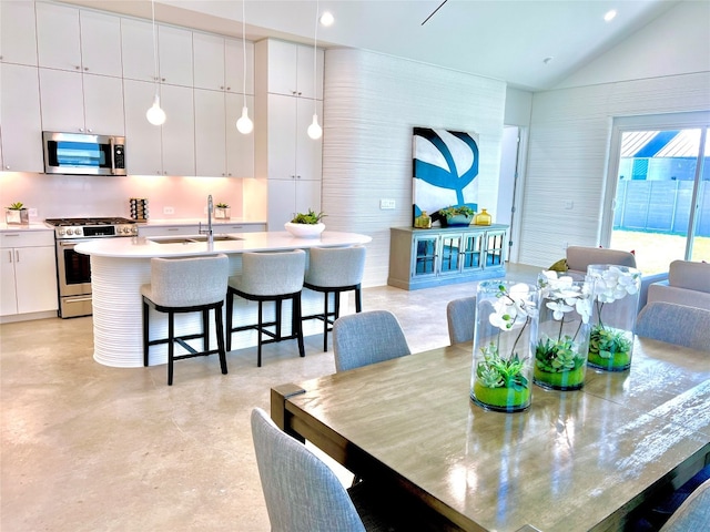 dining area featuring sink and vaulted ceiling