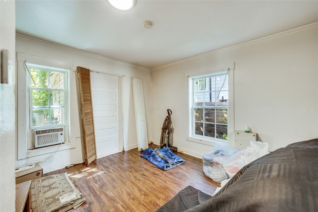 living room with a healthy amount of sunlight, crown molding, and hardwood / wood-style flooring