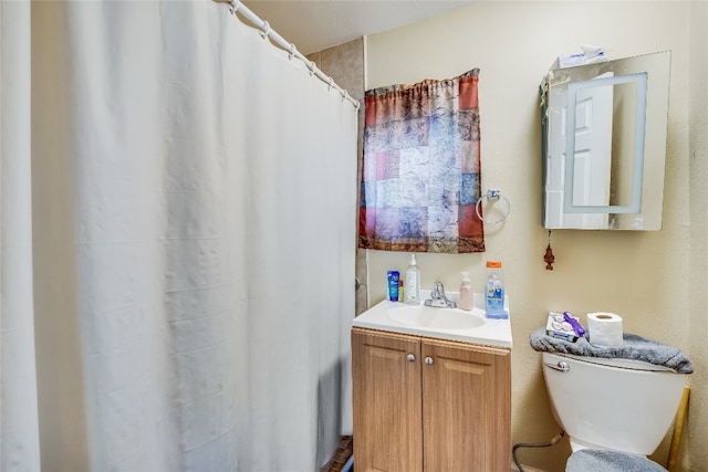 bathroom with a shower with shower curtain, vanity, and toilet