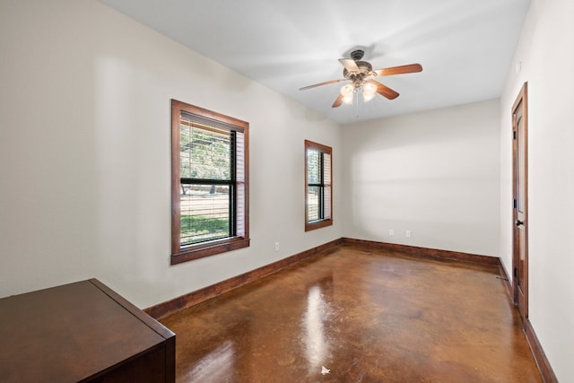 empty room featuring concrete floors and ceiling fan