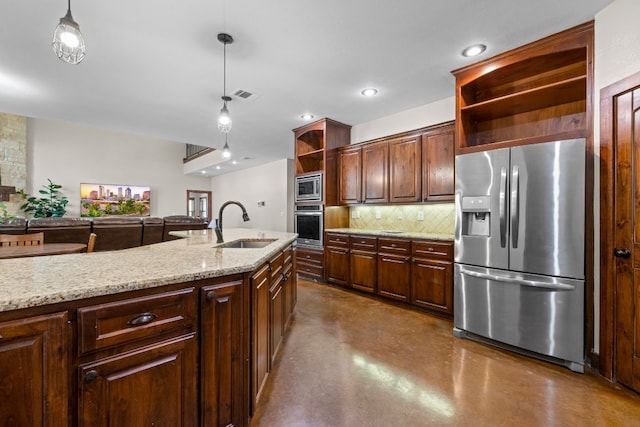 kitchen featuring pendant lighting, sink, concrete floors, appliances with stainless steel finishes, and decorative backsplash