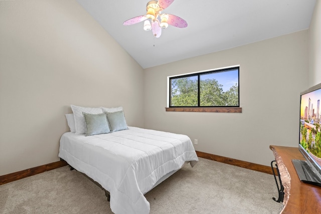 bedroom with vaulted ceiling, ceiling fan, and light colored carpet