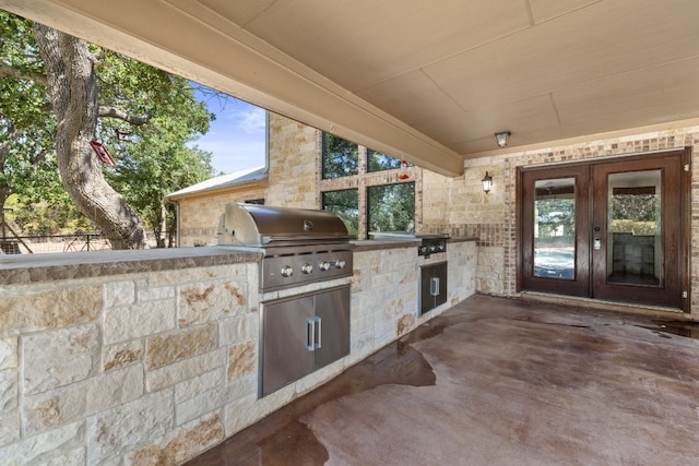 view of patio / terrace featuring french doors, area for grilling, and exterior kitchen