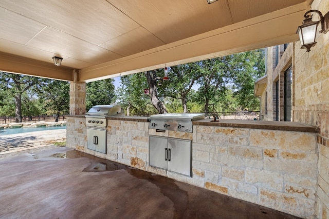 view of patio / terrace with an outdoor kitchen and a grill