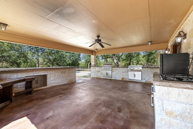 view of patio / terrace with grilling area, ceiling fan, and exterior kitchen