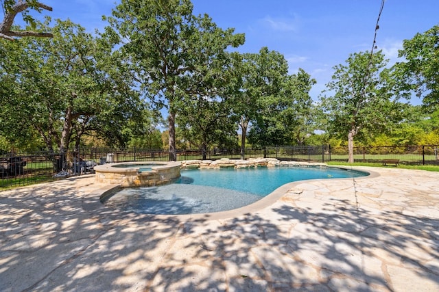 view of swimming pool with an in ground hot tub and a patio area