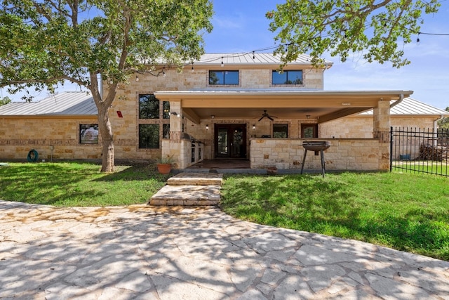 view of front of property with french doors and a front lawn